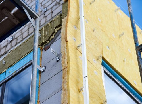 office building under construction. Facing and insulation of walls.